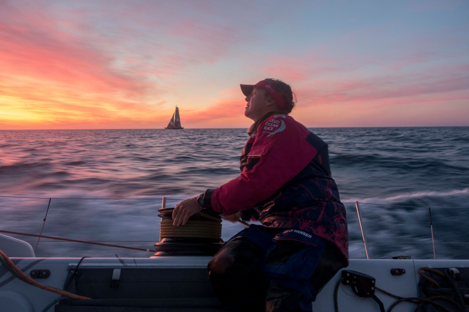 November, 2014. Leg 2 onboard Team SCA. Annie Lush trims as Team SCA and Team Alvimedica race into the sunset.